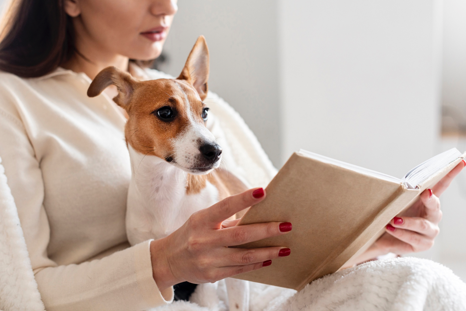 side-view-woman-reading-while-holding-her-dog